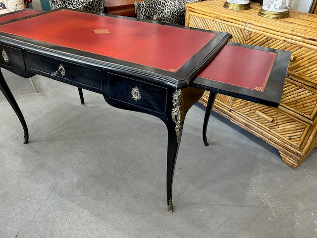 ebonized Louis XV style desk with tooled red leather